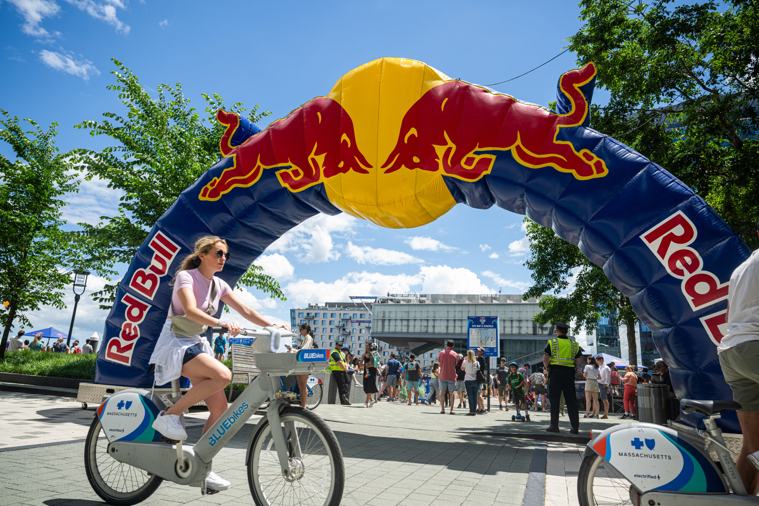 Woman biking in front of Red Bull balloon arch