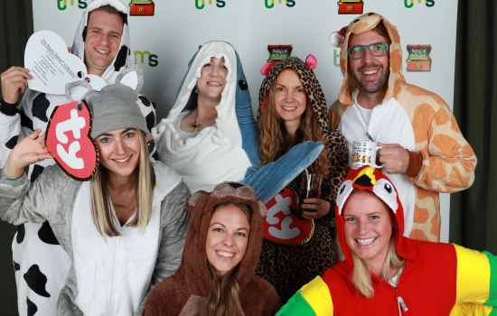 Employees posing for a photo in their Beanie Baby costumes