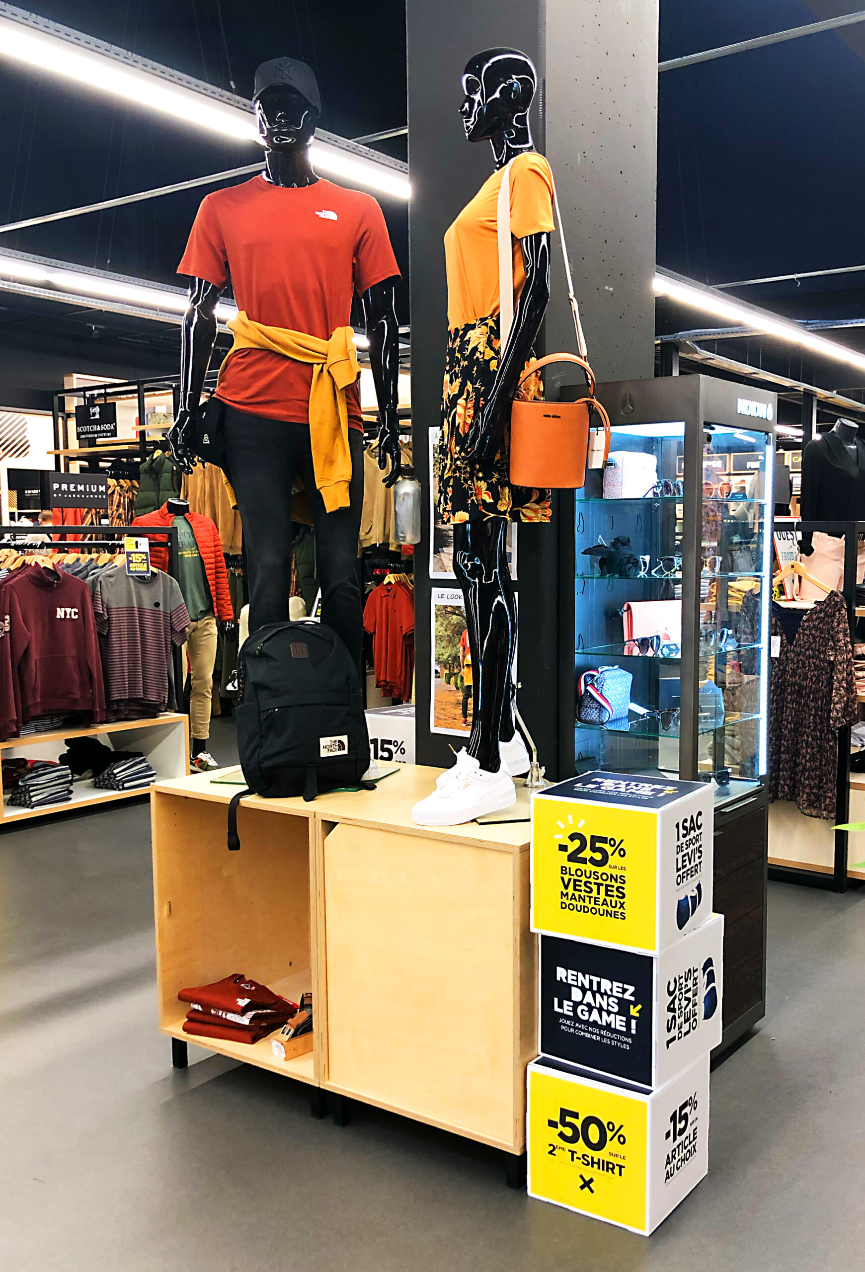 Mannequins at Blackstore with promotional signage