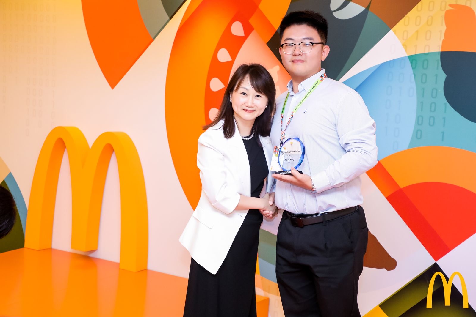 Two people with trophy posing