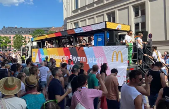 The McDonald's pride parade truck in front of a large crowd